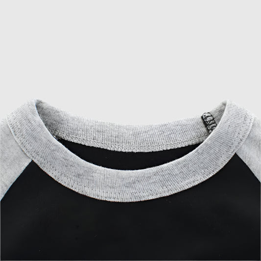 Close-up of the collar on the black 'Let's Play! ROARRR' long sleeve kids' t-shirt, showing the quality stitching and comfortable fabric.