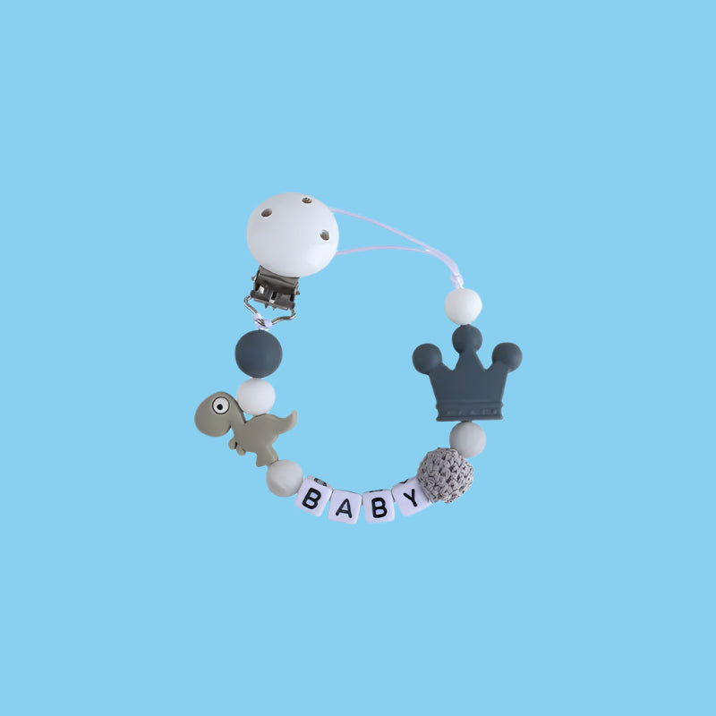 Gray Little Dino Silicone Pacifier Chain with a secure Hemu pacifier clip and a playful dinosaur design.