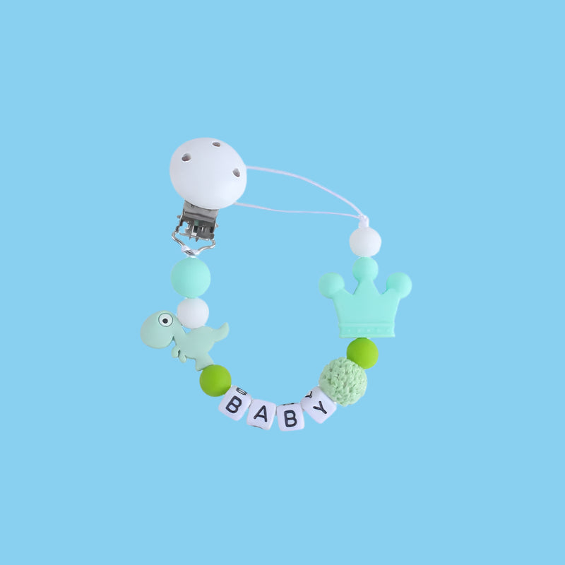 Green Little Dino Silicone Pacifier Chain with a secure Hemu pacifier clip and a playful dinosaur design.