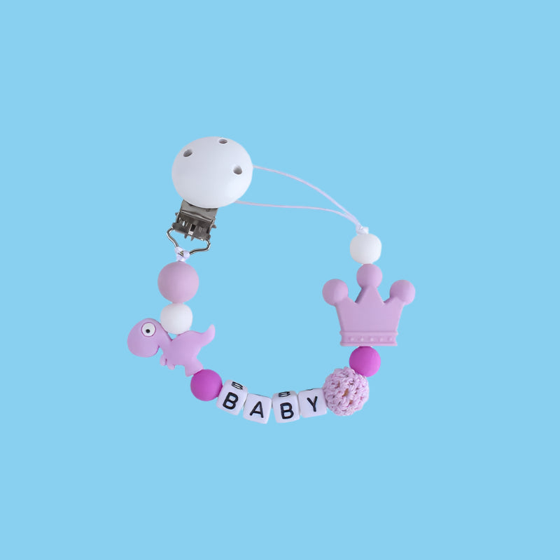 Purple Little Dino Silicone Pacifier Chain with a secure Hemu pacifier clip and a playful dinosaur design.